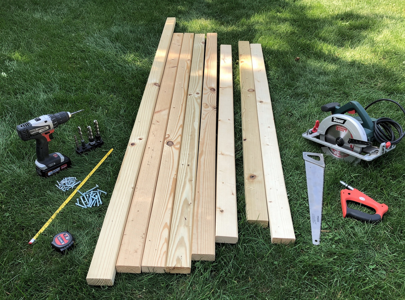 Construction tools and lumber laid out for chicken coop build