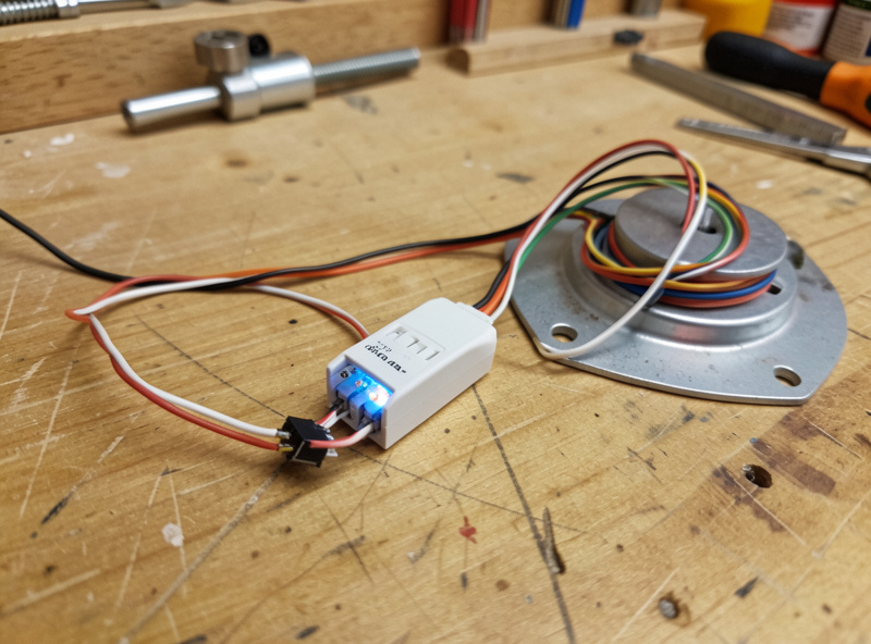 A small smart LED dimmer module wired to a coop light fixture with neat low-voltage wiring