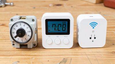 A mechanical dial timer, a digital LCD timer, and a Wi-Fi smart plug arranged side by side for comparison